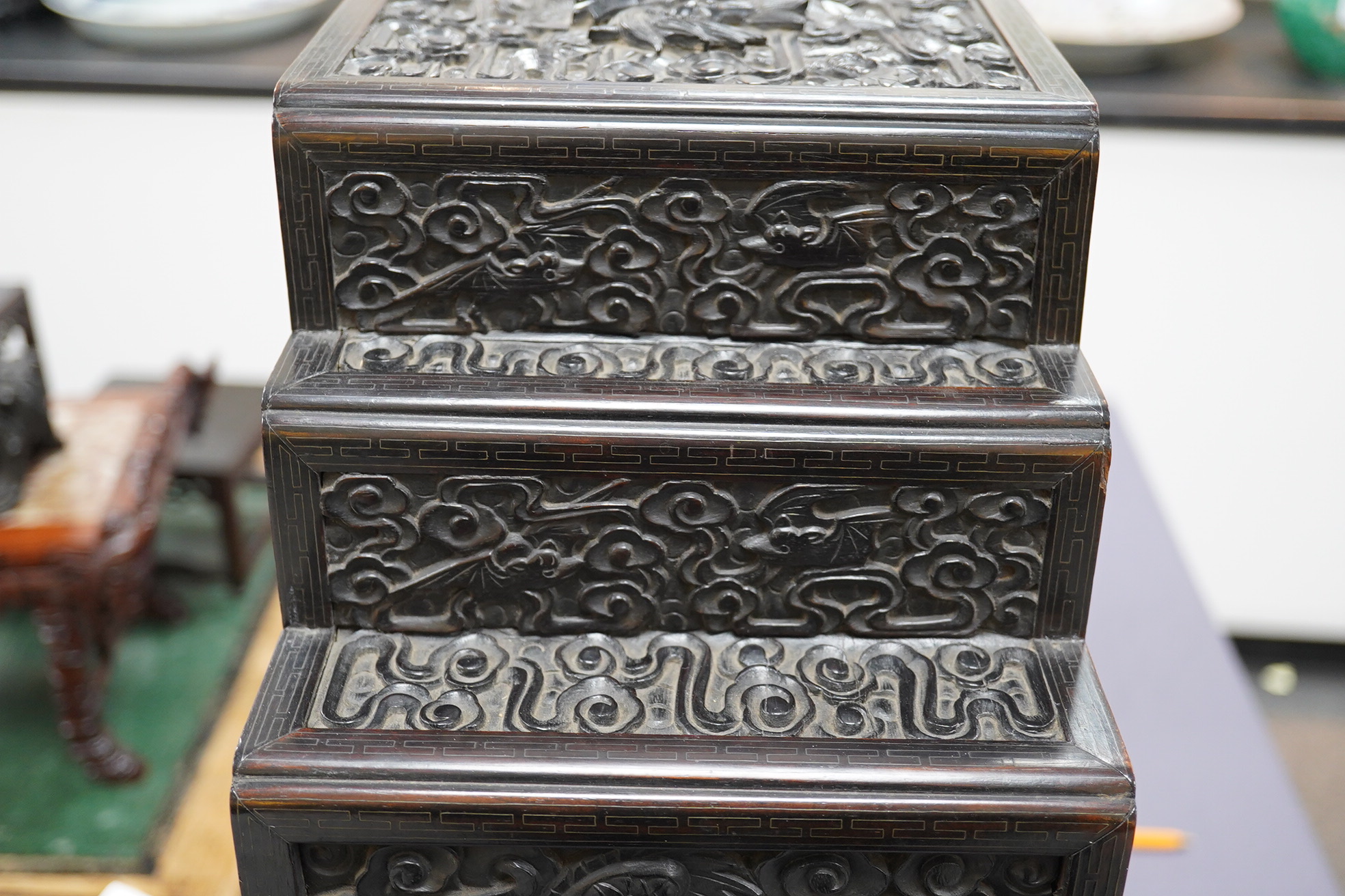 An important pair of Chinese carved zitan and silver wire inlaid ‘cloud and dragon’ curio cabinets and stands, duobaoge, probably Imperial, late Qing dynasty